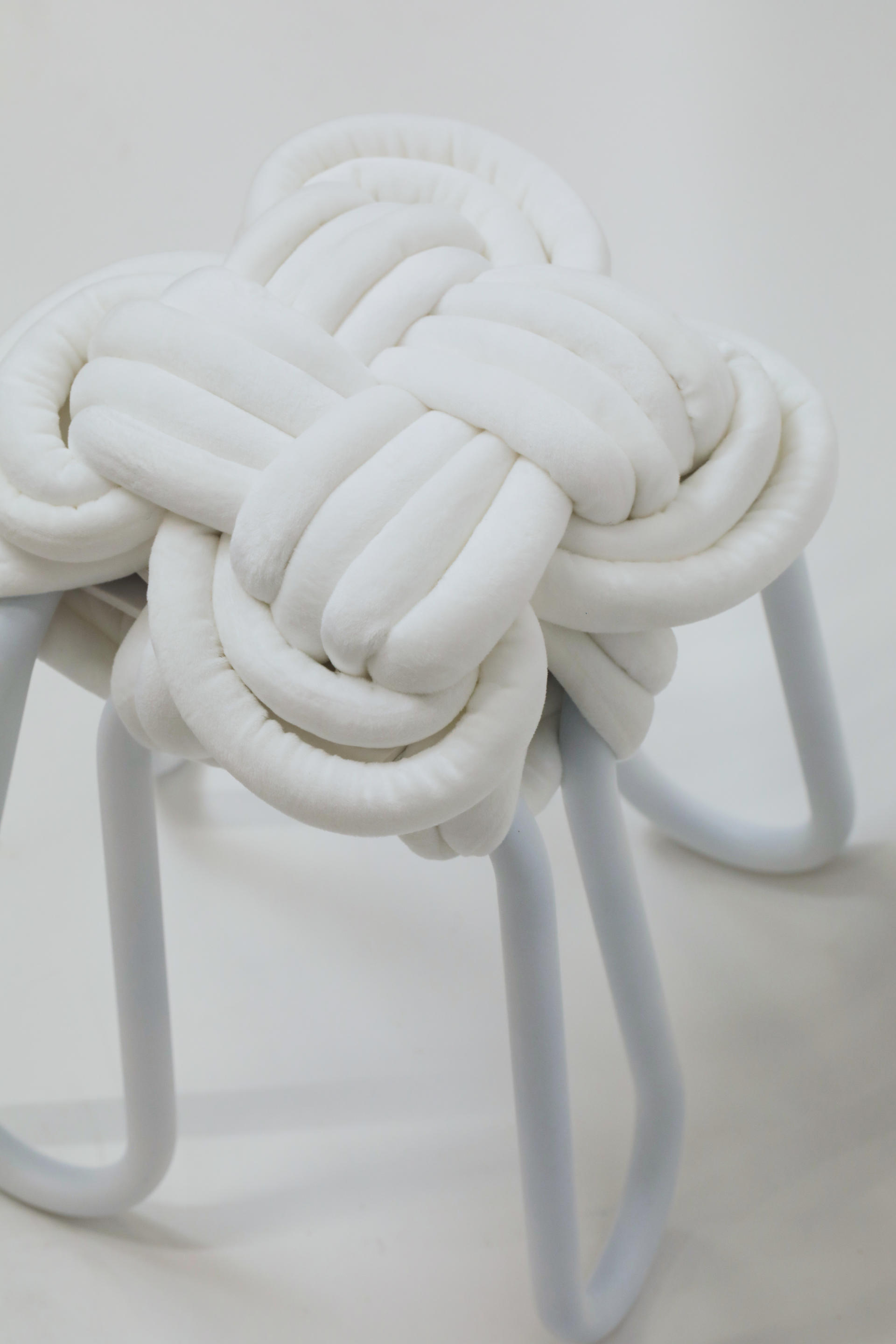 Close view of white knot stool on a white background