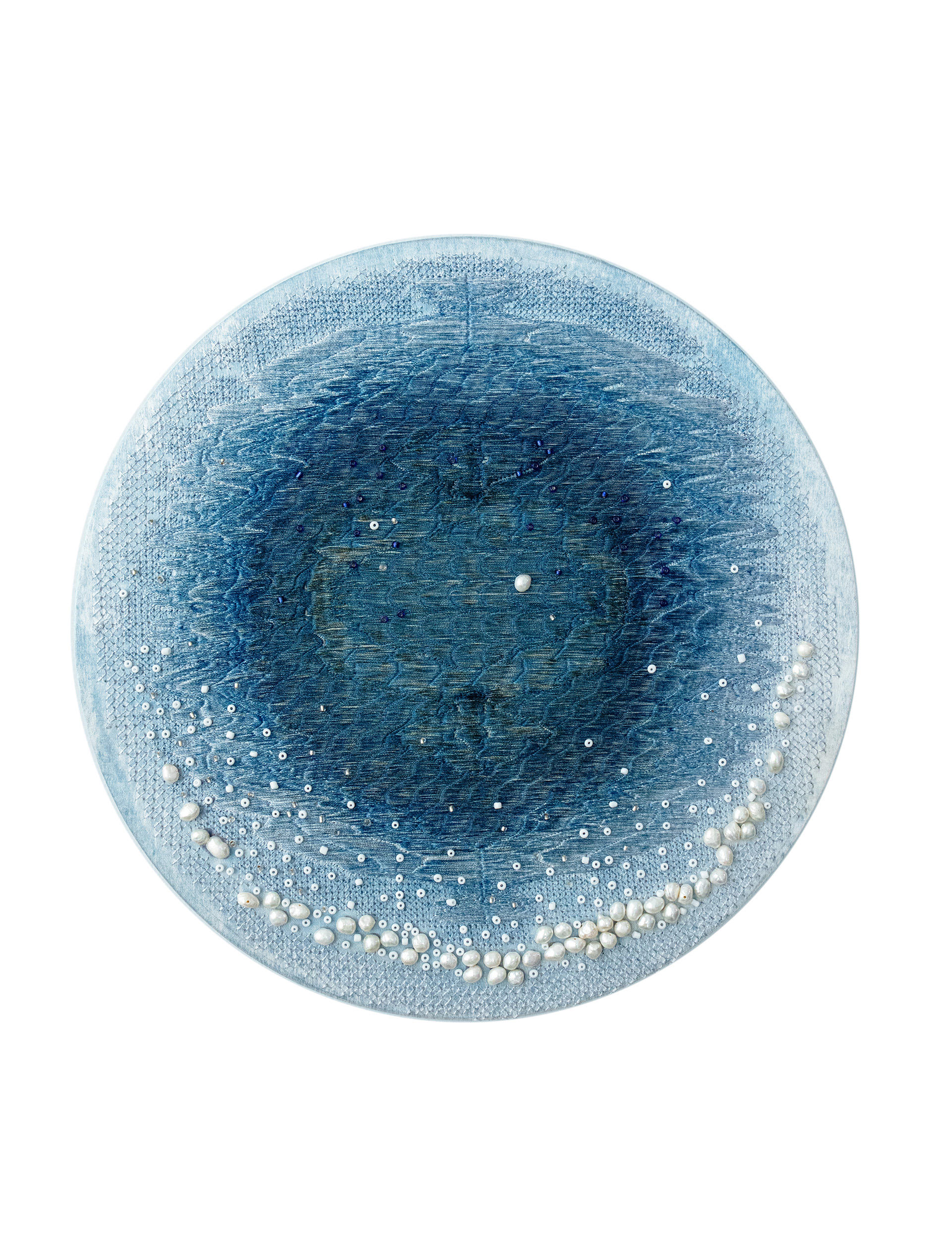 On a silk dyed light blue, I used embroidery and beadwork to create a pattern similar to the blue hole of the ocean.
