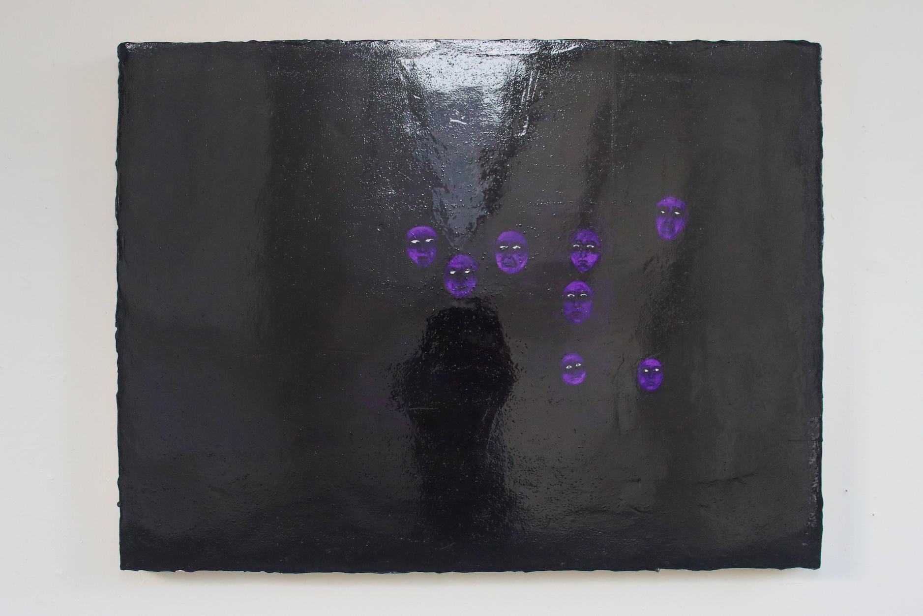 A reflective violet painting with only visible faces 