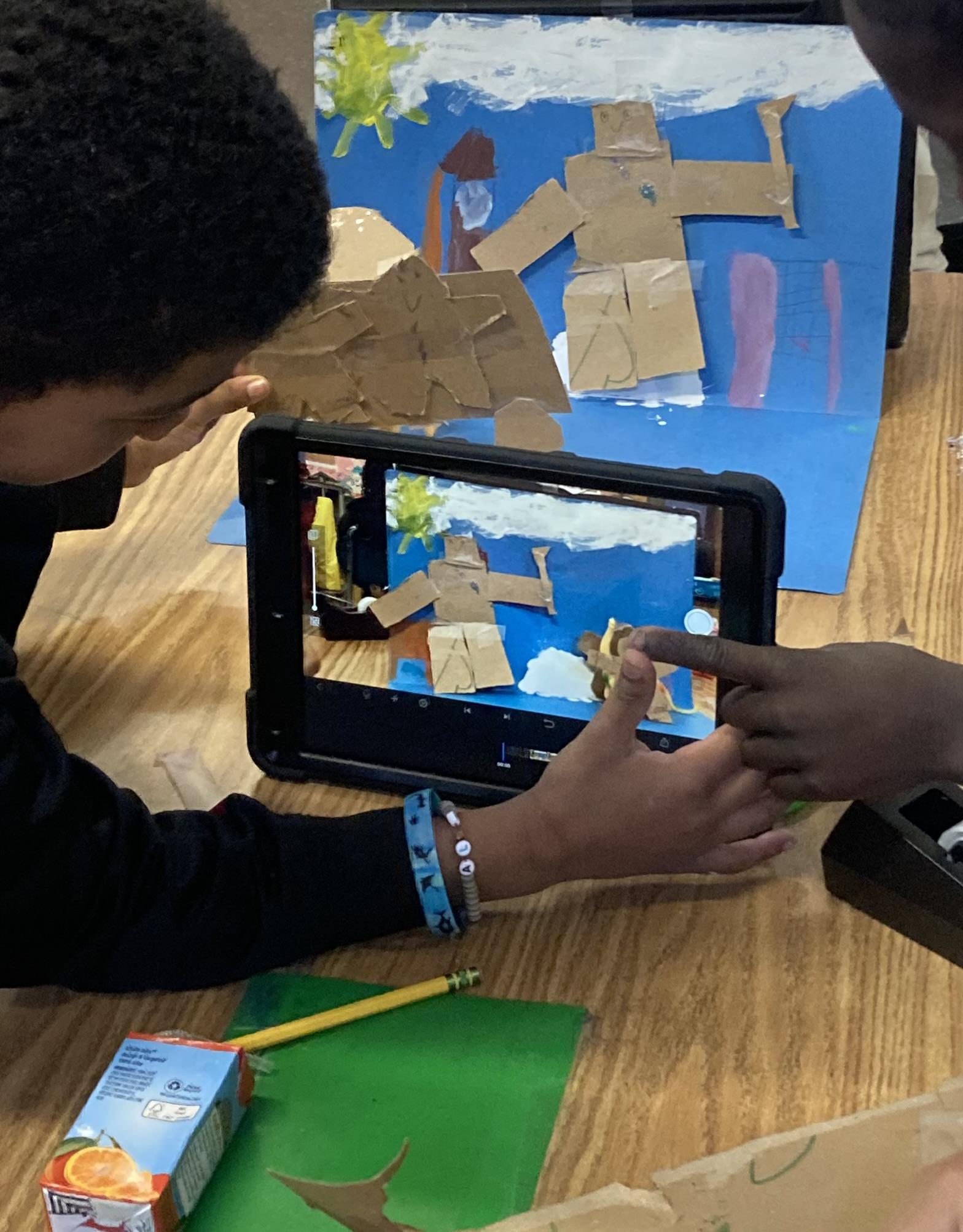 Two fourth grade students work together to film stop motion animation.