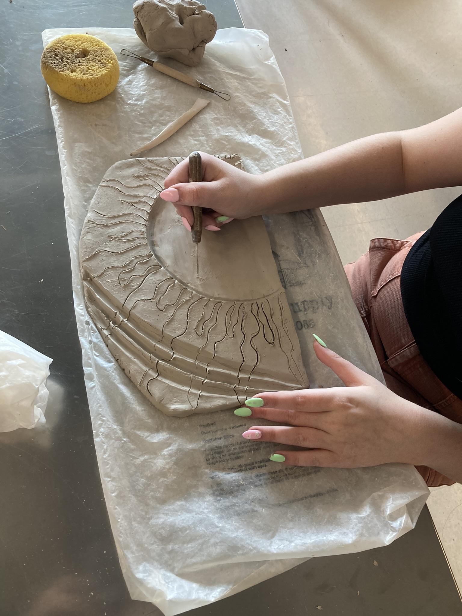 High school student handbuilds a ceramic mural piece