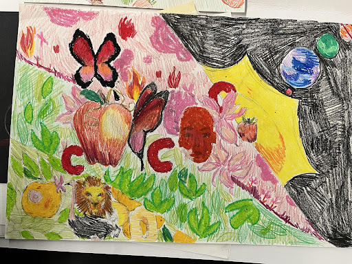Vividly colored oil pastel and colored pencil drawing depicting the solar system, a red face in front of a pink face, two butterflies, one perched on an apple, a second smaller apple, flames, flowers, green leaves, red “c” shapes, a yellow lion next to an ostrich, and yellow fruit.