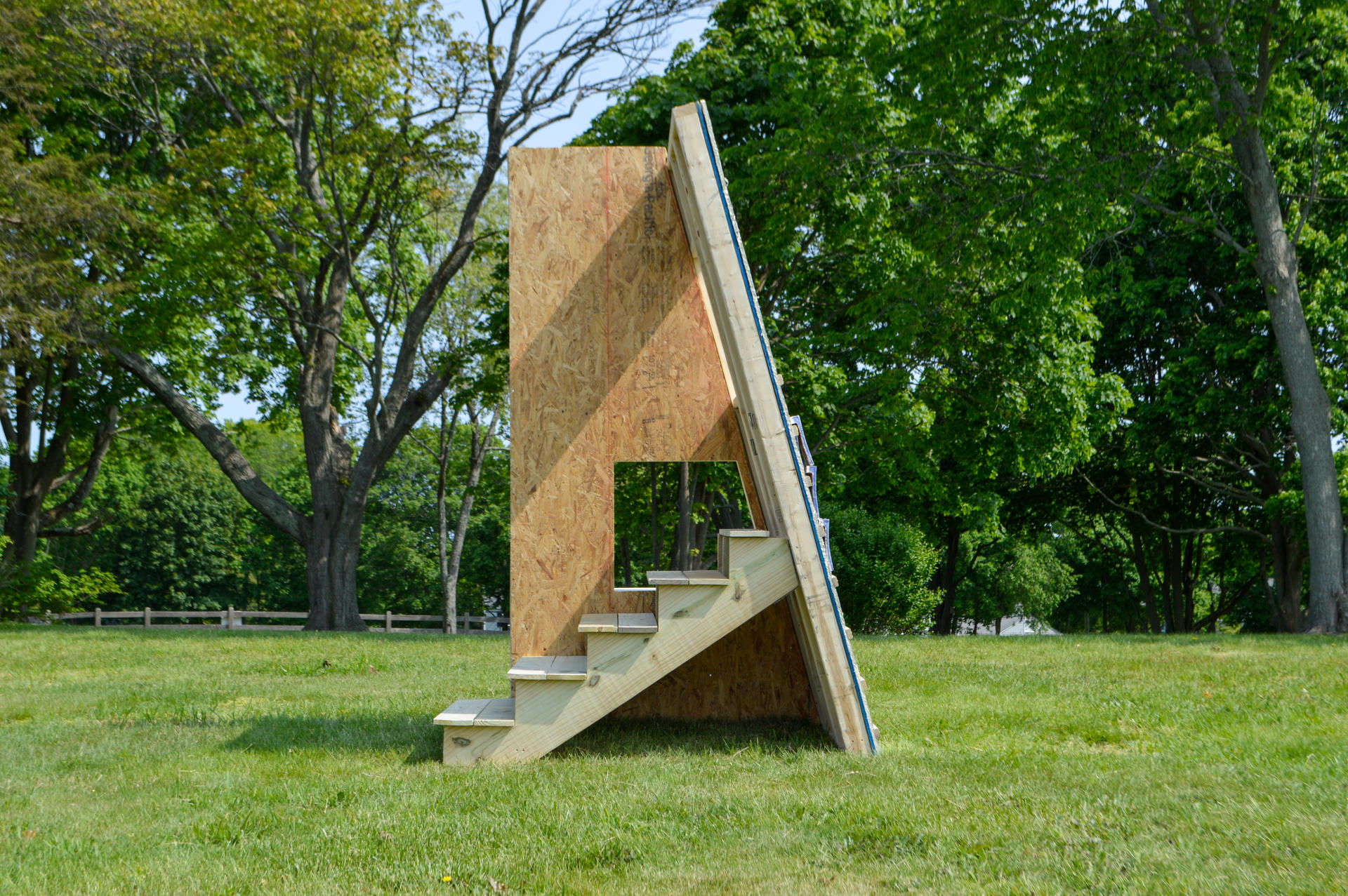 Sculpture in green field.