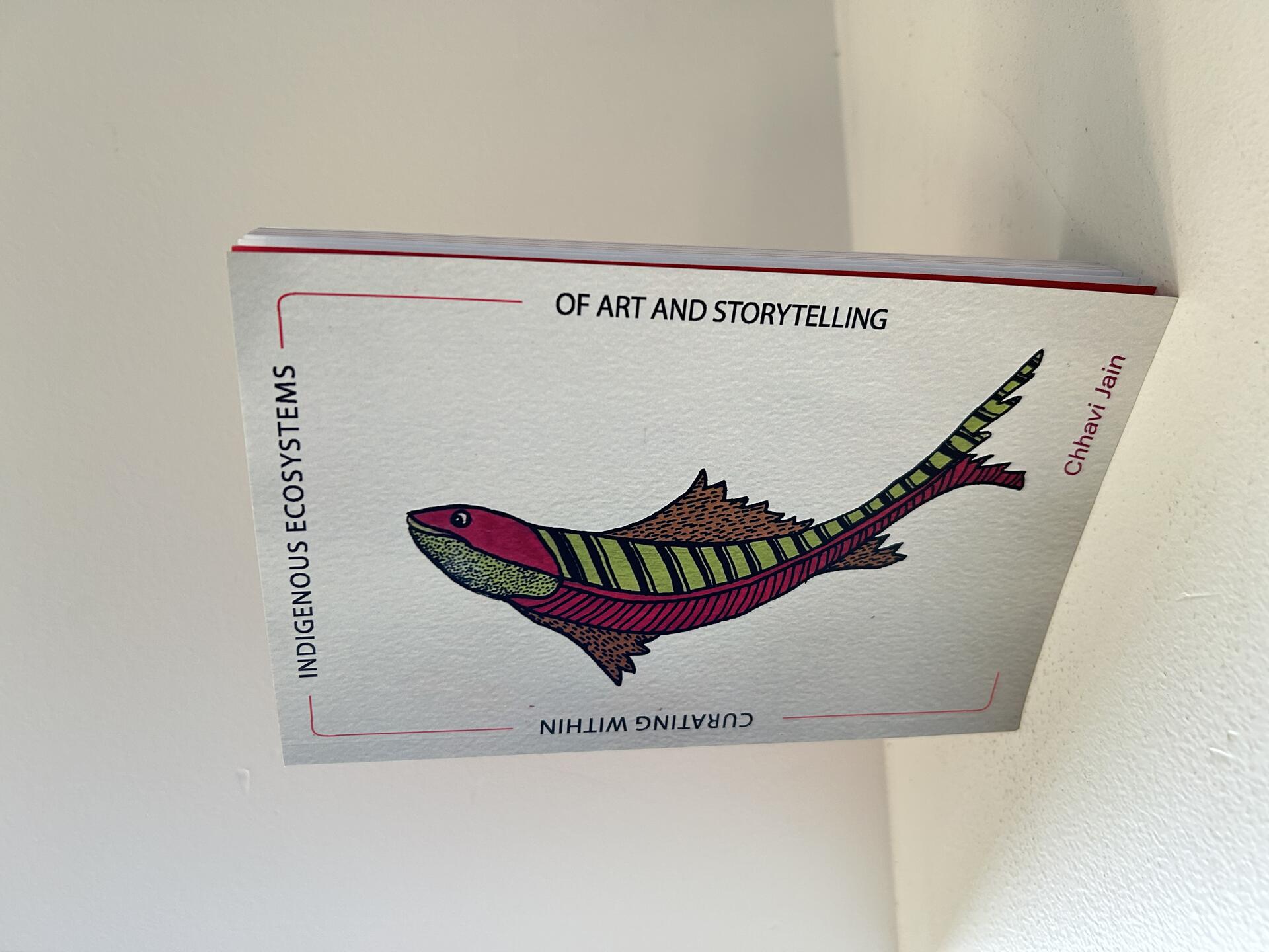 Image of the Book featuring an artwork- pink and green fish looking upwards.