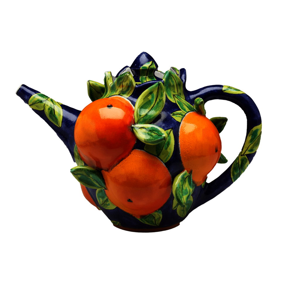 A dark blue teapot covered in oranges and green leaves in high relief.