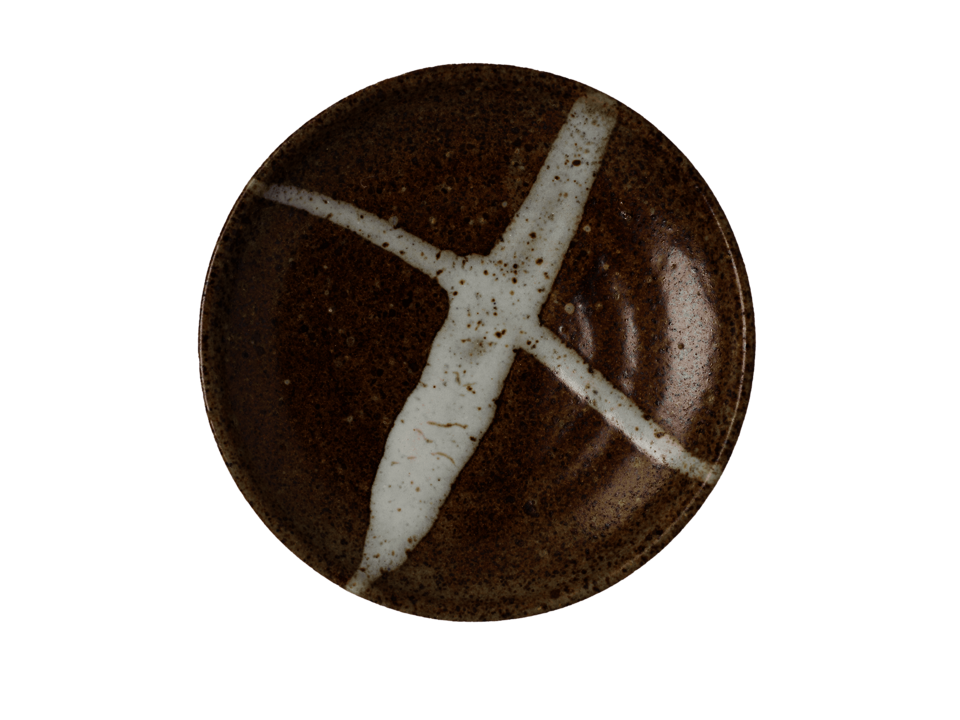 Brown ceramic plate with two white lines criss-crossing