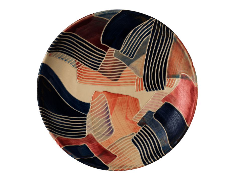 Circulate platter covered in solid and striped brushstrokes of different colors.
