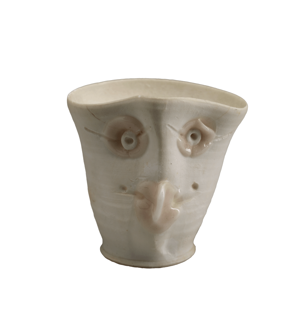 A white open vessel with a face.