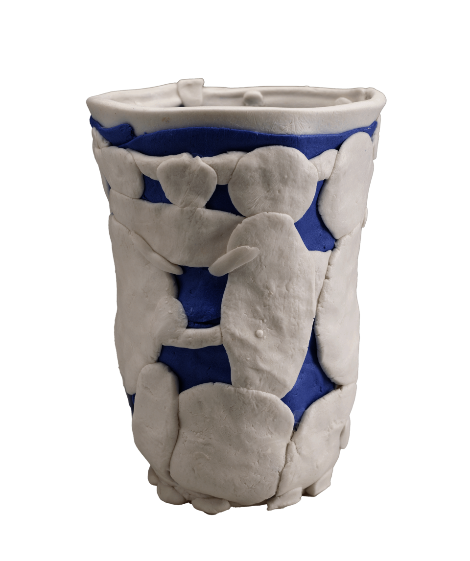 An open vessel constructed of white and blue pieces of clay in various shapes, layered on top of one another. 