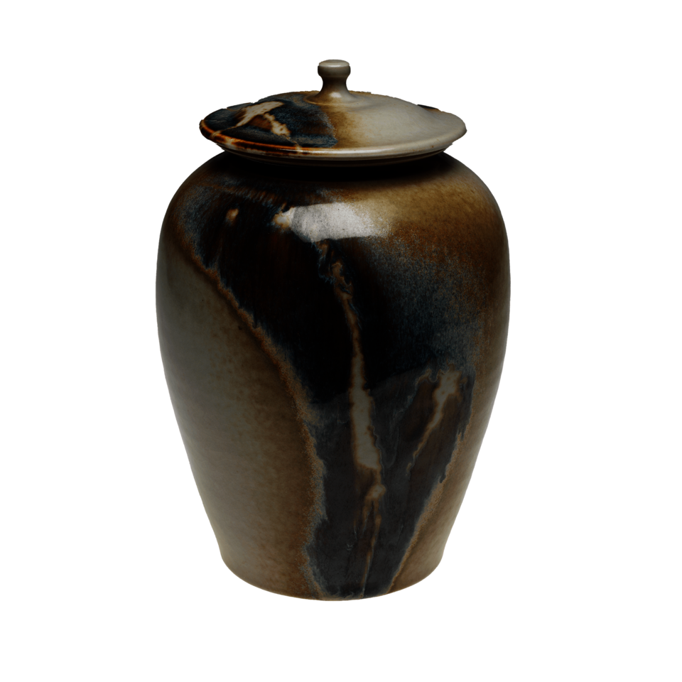 Lidded jar covered in shades of brown, blue, and cream.