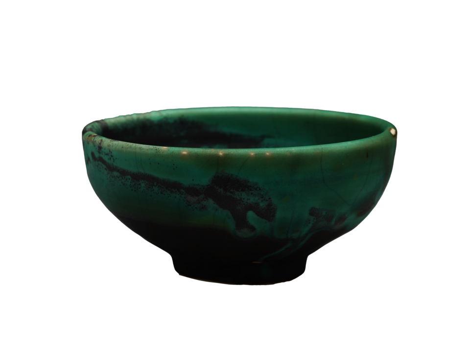 Green bowl with splashes of dark gray on side and at base.