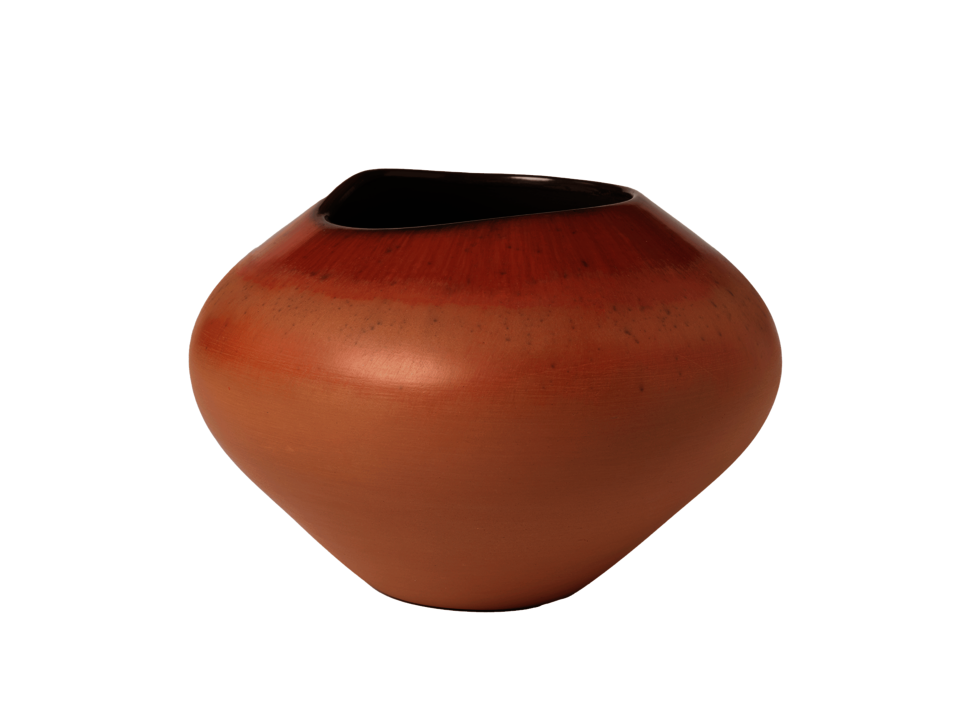 Bulbous tan-orange colored pot with uneven dark colored rim.