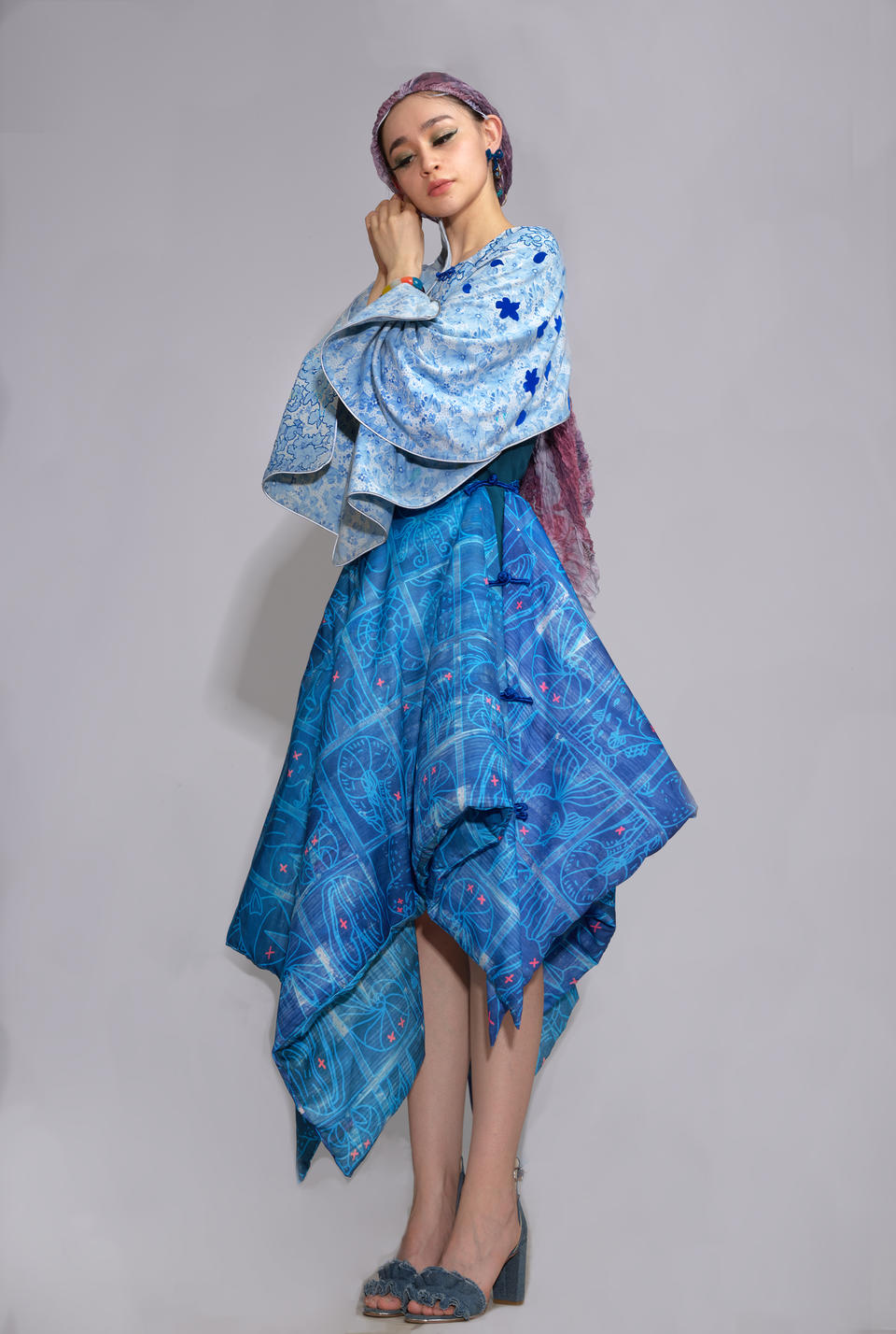  the recycled bed sheet cape and a wearable blanket skirt, with a dress wig