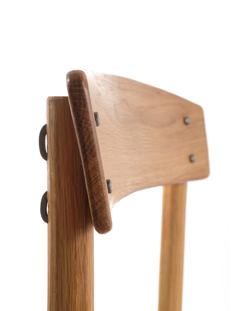 Detail photo of Kentucky Danish showing the attachment of the back rest. The original J39 backrest is attached via screws covered by wood plugs. Screws were out of reach of the craftspeople of the Appalachian Mountains in the 18th and 19th century, so instead the backrest of Kentucky Danish is attached with cut and clinched nails.