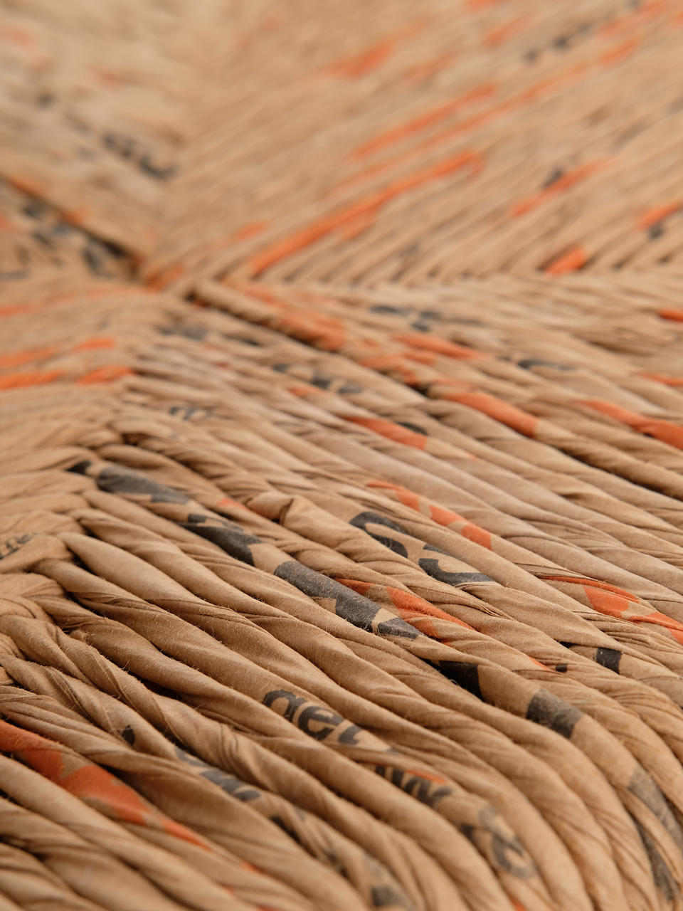 Photo of the woven seat of Big Box Vernacular, made from cut and twisted paper bags intended for lawn waste.