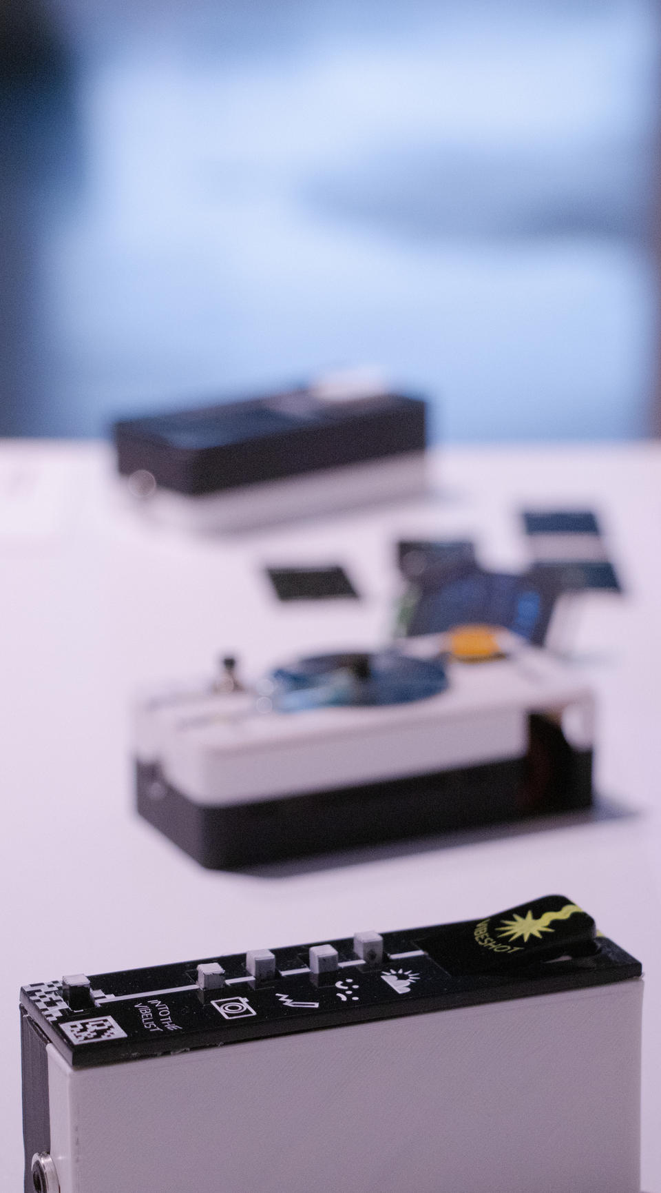 Portrait oriented photograph (vertical) showing the three devices. top to bottom: reaction tile, monofilter, vibelist. The vibelist is in focus, the rest are blurry.