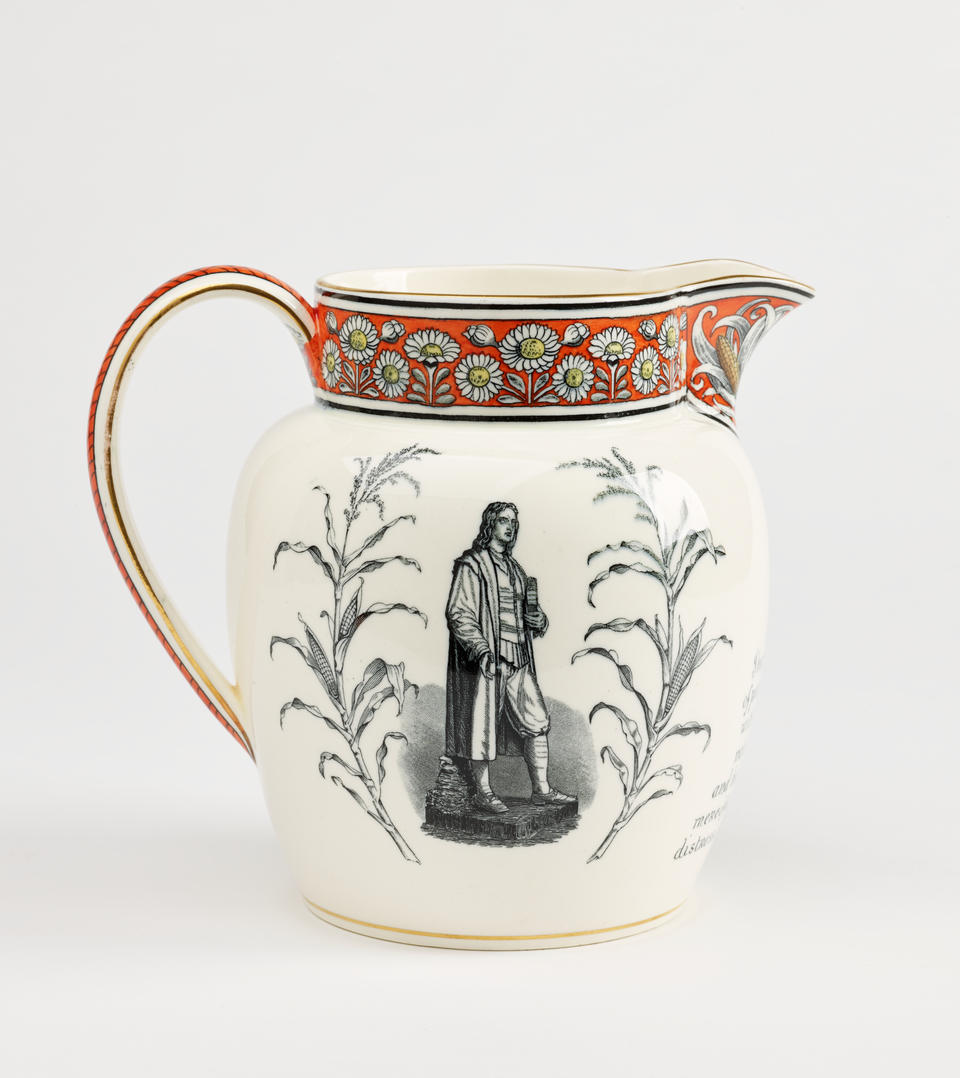 A  jug with a handle, lip, with red, yellow, and black daisy decorations, there is a prominent grey tone figure and flora on the body of the vessel.
