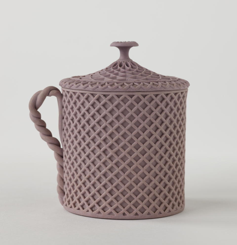 Jasperware custard cup with cover, the entire vessel and lid has a raised woven texture. The handle is sculptural and swirled.