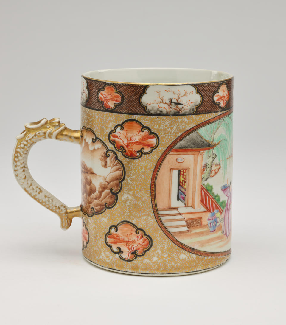 A porcelain tankard with a handle that has delicate enamel and gilded decorations.