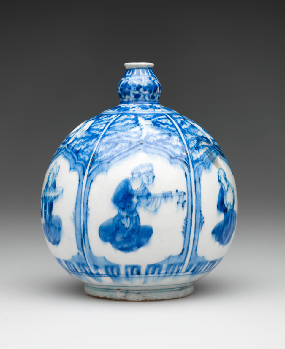 A bulbous white and blue vessel with a small neck and a hole on the side. There is a repeating window shape with different figures inside the vignet. 