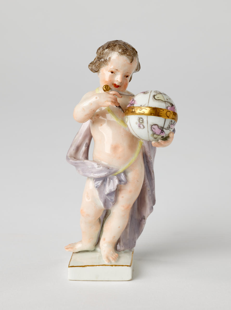 A sculptural putto figure holding a globe that is gilded. The putto has brown hair, red lips, and a light purple fabric draped across it. 