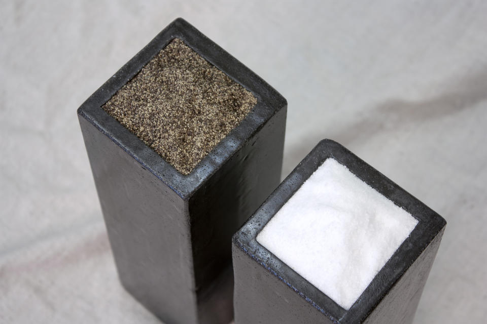Two cement rectangles, for a table setting to hold salt and pepper.