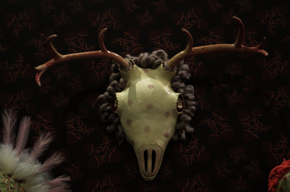 Ceramic mask of skull and antlers.