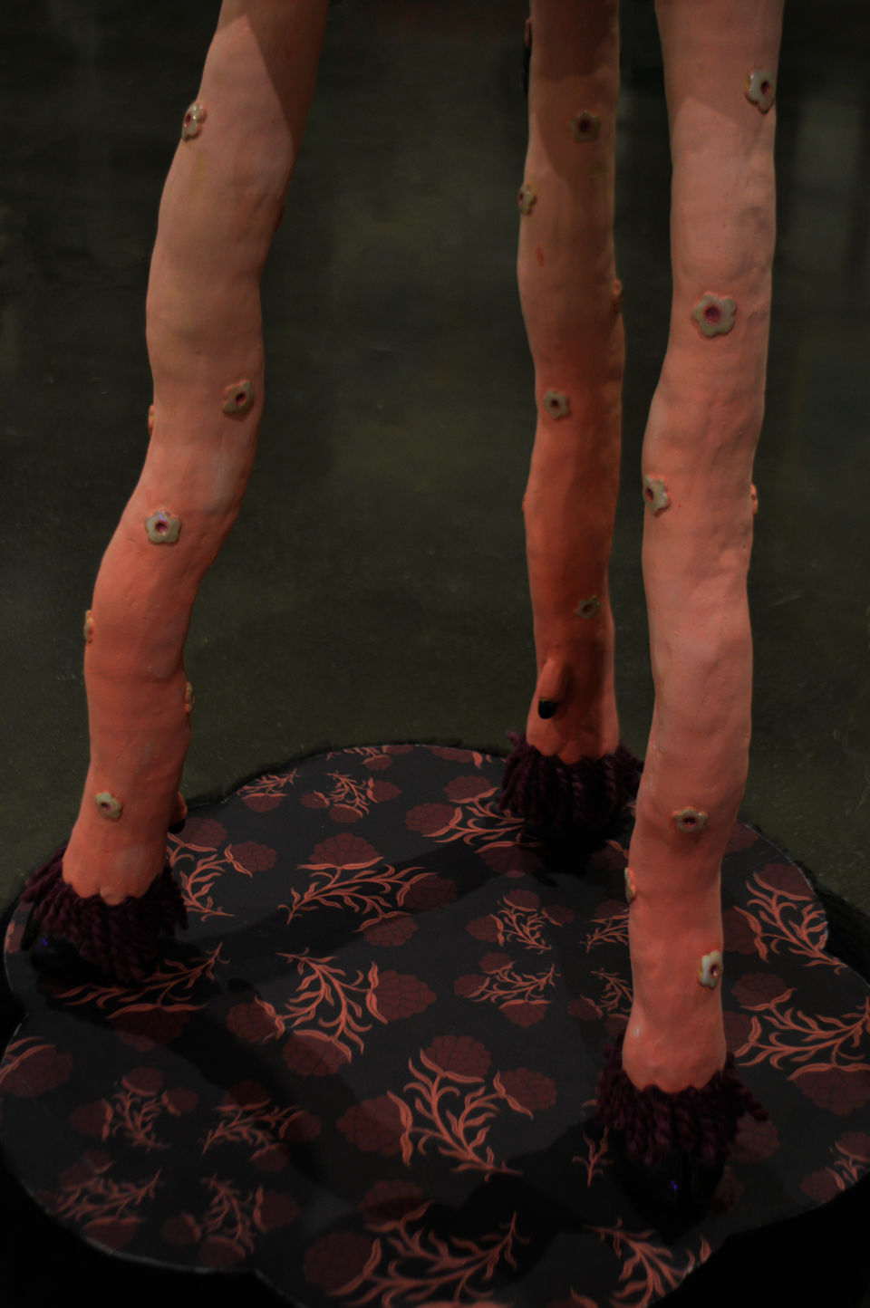 Wavy pink ceramic table legs with hooves.