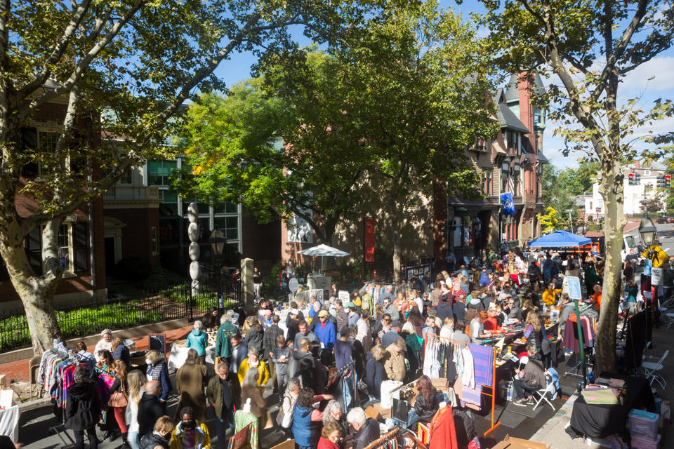A crowd of people fill a street for a sidewalk craft sale in front of the Benefit Street entrance of the RISD Museum.