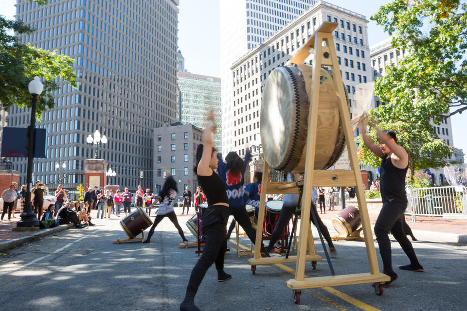 RISD/Brown's Japanese drumming group, Gendo Taiko, performs on the street in downtown Providence by the College Street bridge.