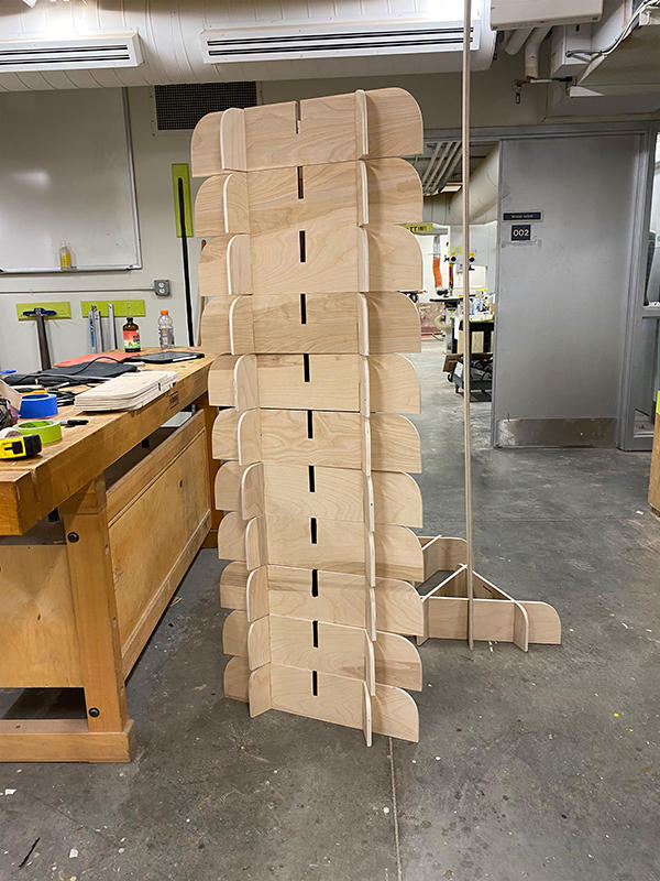 Stacks of birch plywood triangular bases for the monument in a woodshop