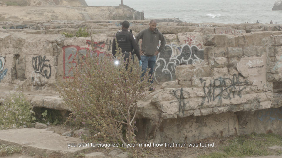 Two men are standing in the ruins