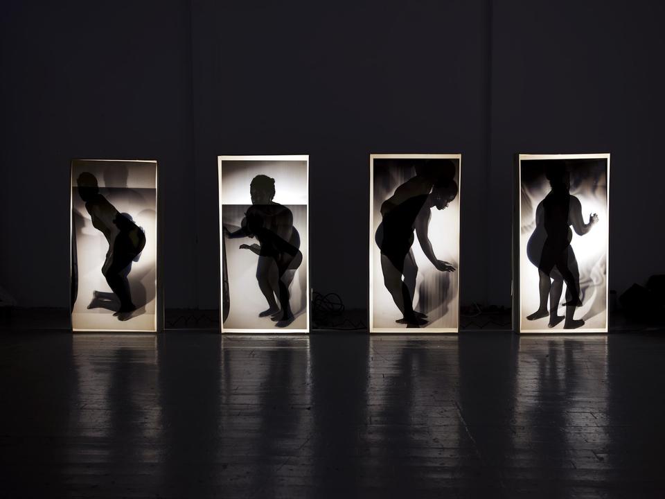 light boxes with twinned figures illuminated on top