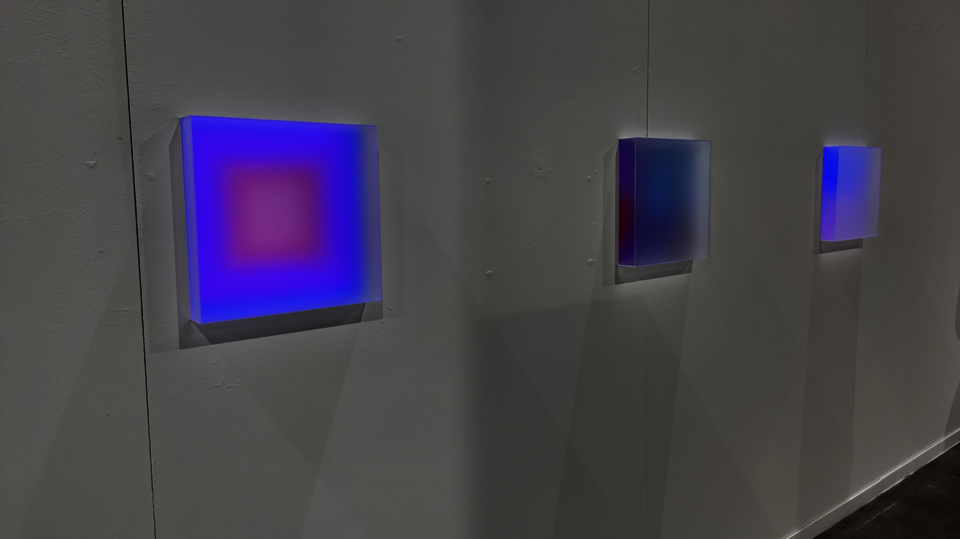 Photo documentation of installation featuring a close-up of three light boxes.