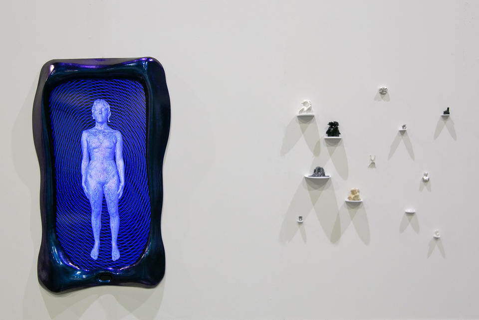 A blue and purple frame surrounds a screen showing a cyborg like figure