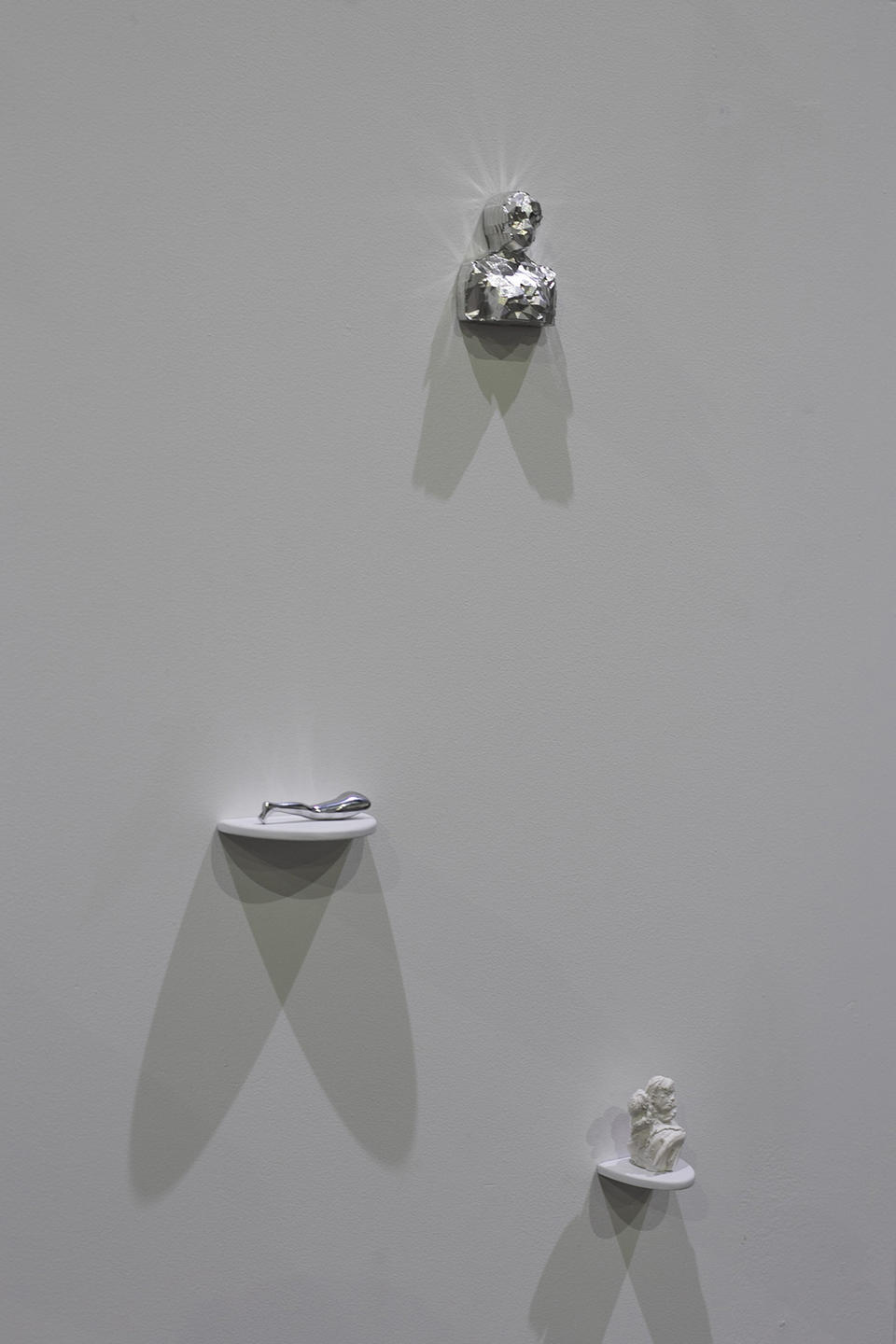 A detail shot of multiple sculptures on individual shelves