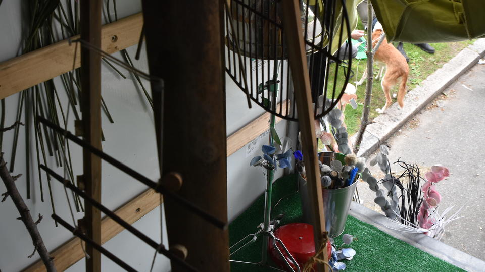 Sticks, metal objects, fake flowers inside a U-Haul truck as part of found object noise garden. 