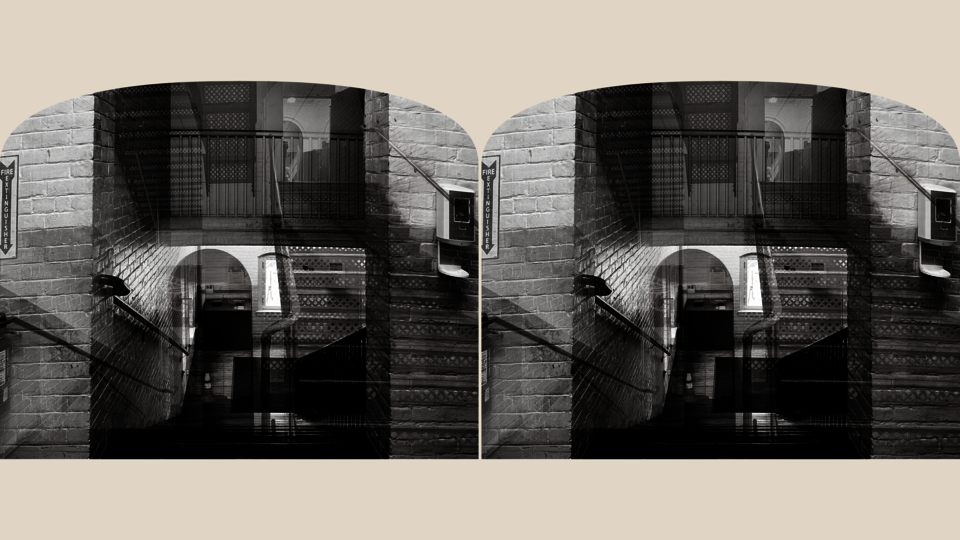 A black-and-white stereoscopic image of the Waterman interior staircase. The symmetrical composition features mirrored perspectives and visible architectural details, creating a sense of movement and capturing the site's dynamic experience.