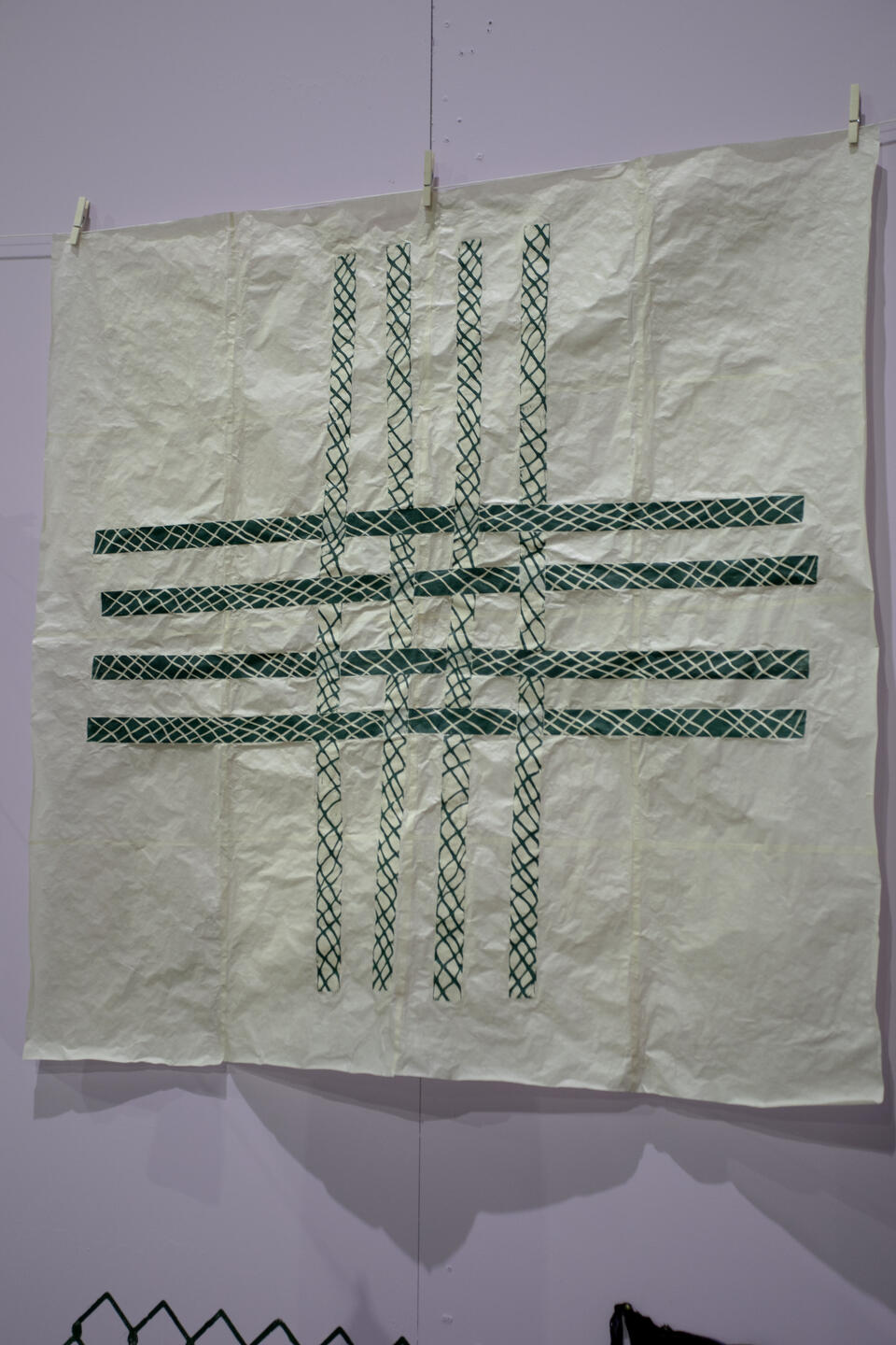 image of green collaged prints assembled in a woven pattern