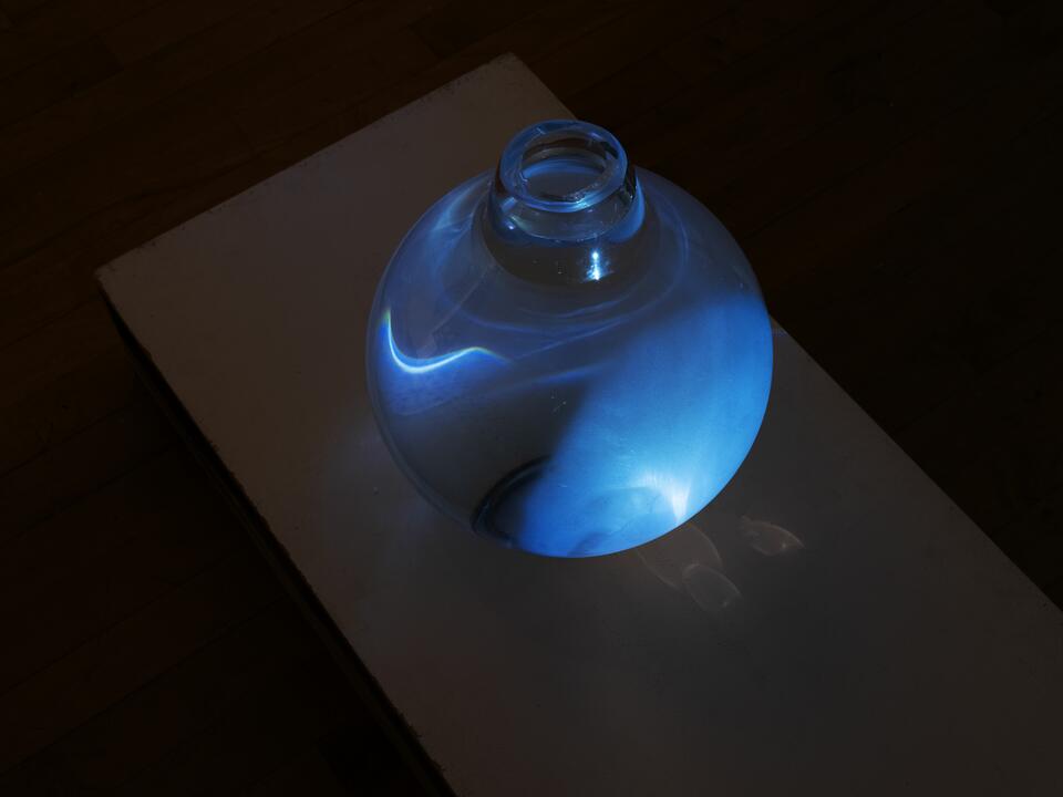 Image of a glass orb with blue light, water