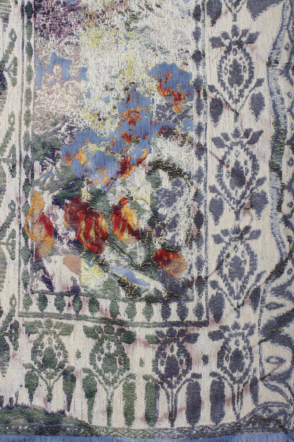 Close-up detail of a woven textile depicting an abstract floral pattern in a washed-out color palette.