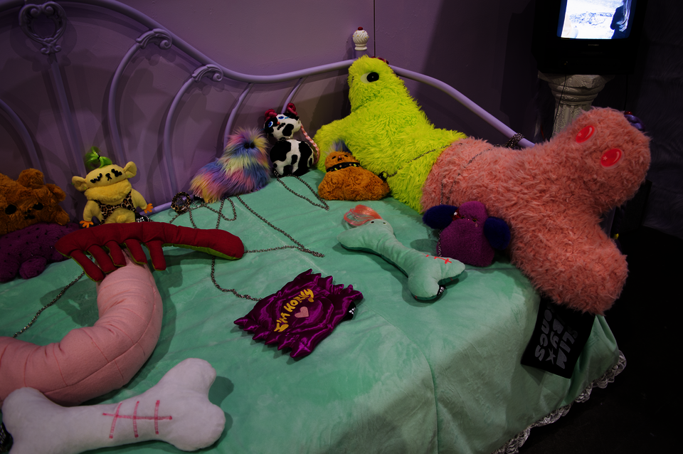 Photograph of toys on a bed.