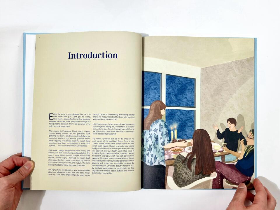 A photograph of the spread of the Introduction Page featuring an illustration of a home dinner scene on the right side and text on the left page.