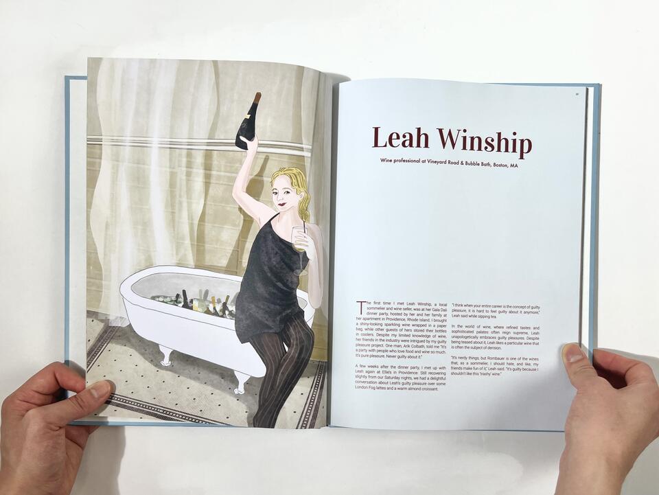 A photograph of a book spread featuring an illustrated woman holding a wine bottle on the left page, and interview profile of "Leah Winship" on the right page 