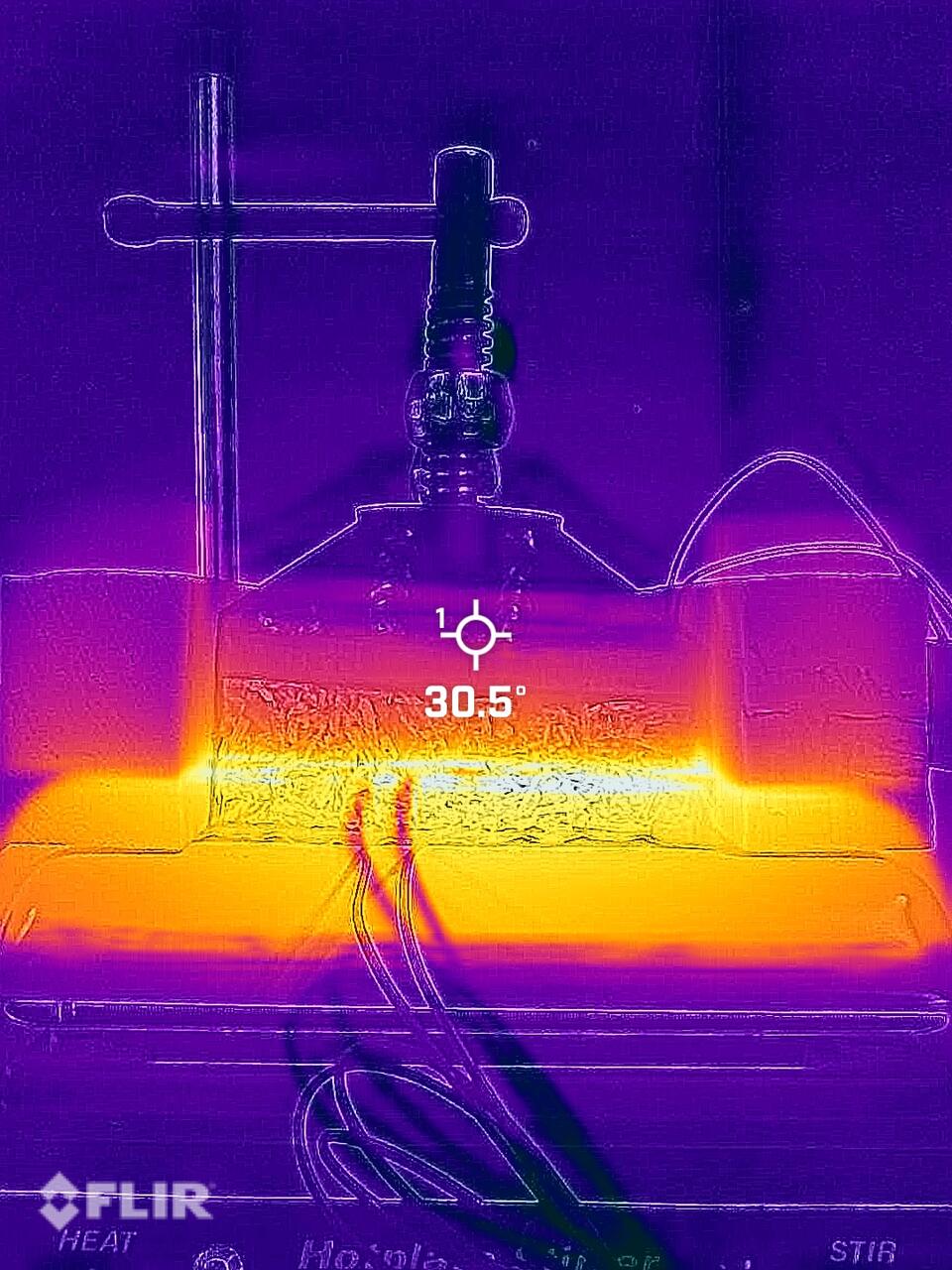 An infrared photograph of a thermal conduction test on a Japanese Knotweed composite block showing a temperature gradient.