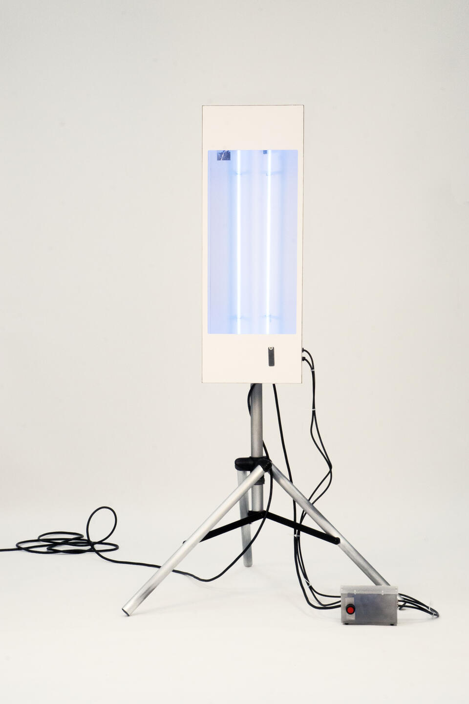 White box mounted on aluminum tripod with two blue neon tubes inside